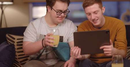 Two men discussing money while looking at a tablet