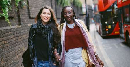 Two young women walking and chatting