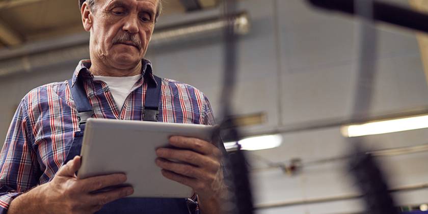 Middle-aged man looking down at his ipad