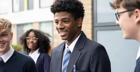 Teenage pupils chatting outside school