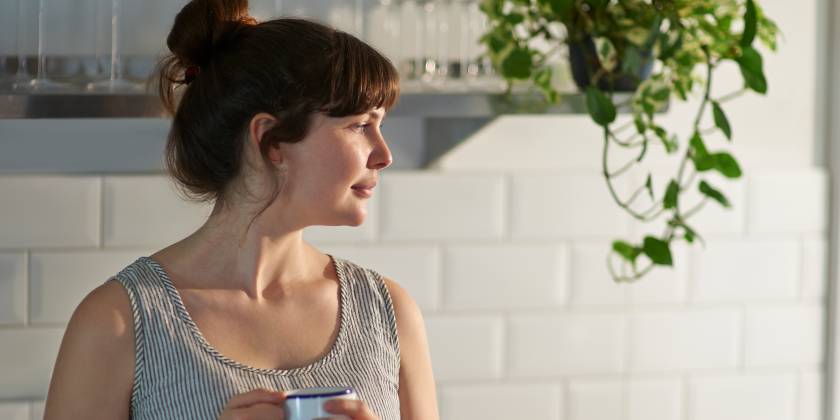 Woman drinking coffee thinking