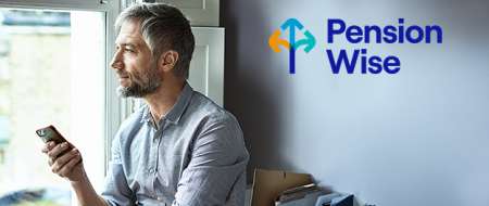 Pension Wise man by window holding mobile phone