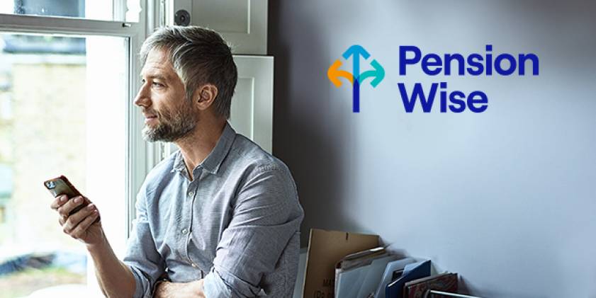 Pension Wise man by window holding mobile phone