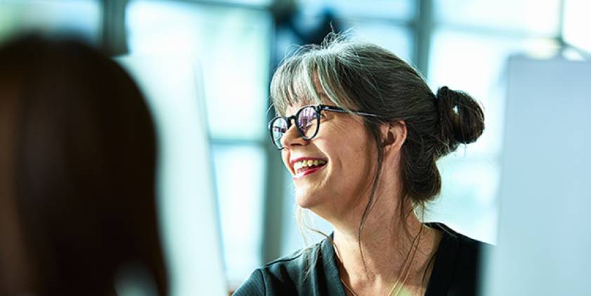 Woman happy at work wearing red lipstick