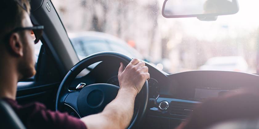 A man in a car driving